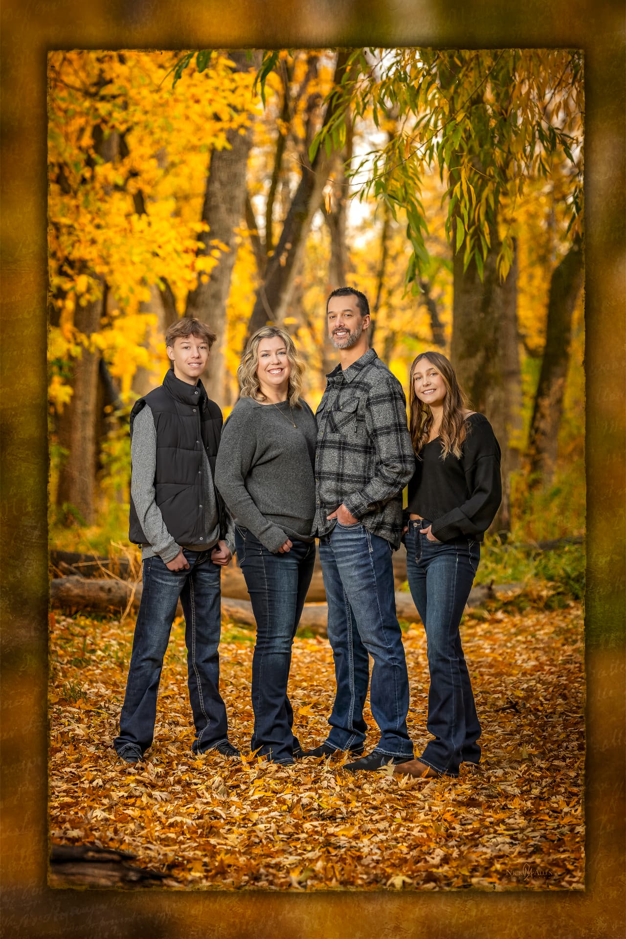 Family standing among fallen autumn leaves